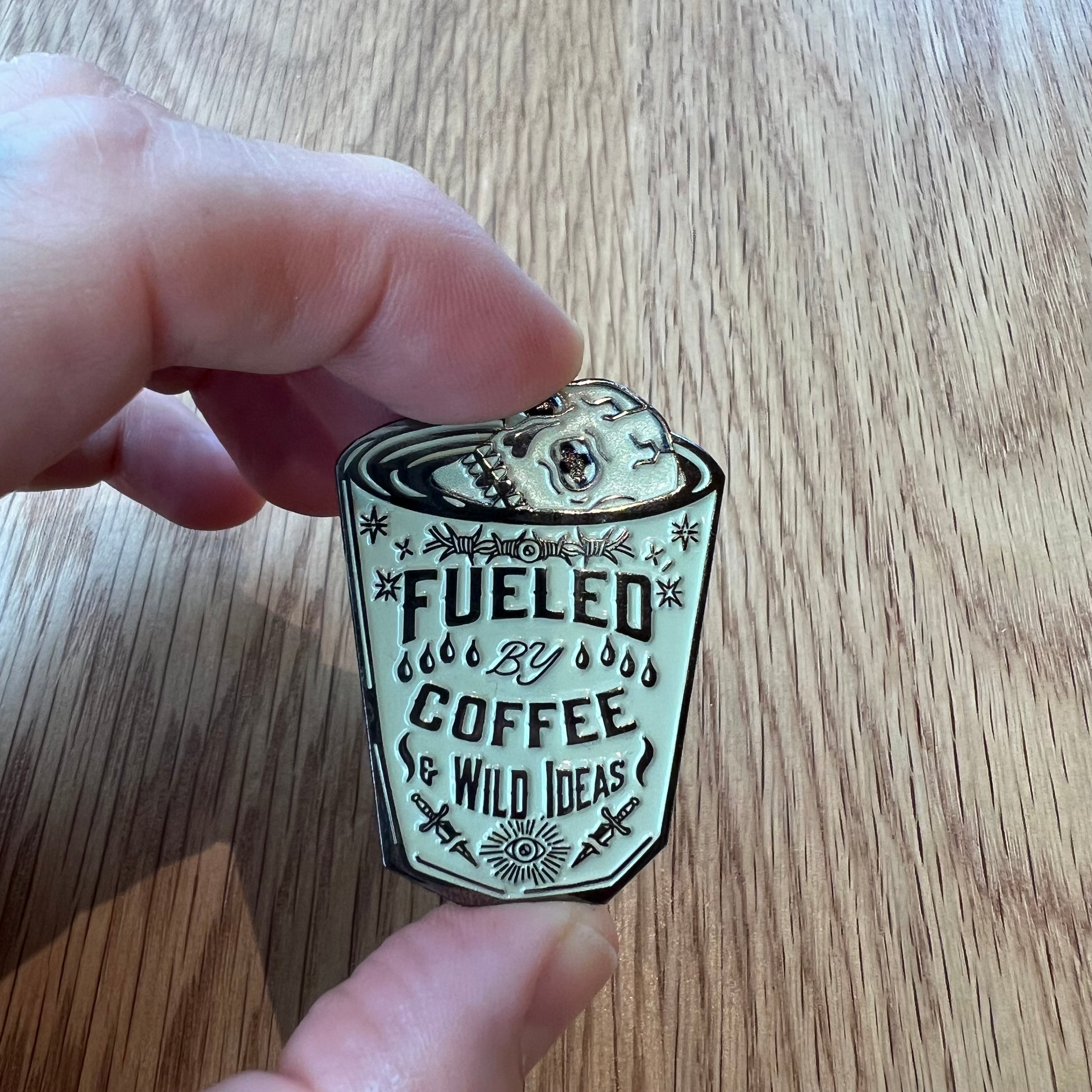 Coffee & Wild Ideas pin attached to card – double post closure and rubber backing visible.