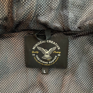 Close-up of Thunder Bird jacket hood showing embroidered Mindzai logo and drawstring detail.