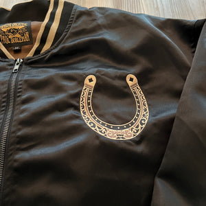 Detail of embroidered motif on chest of Year of the Horse satin bomber jacket.