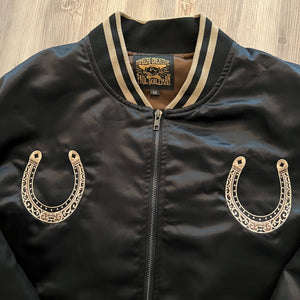 Packaging view of the satin bomber jacket folded inside branded Mindzai box.