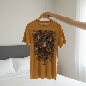 Mustard yellow t-shirt with a decorative design on a hanger against a neutral background.