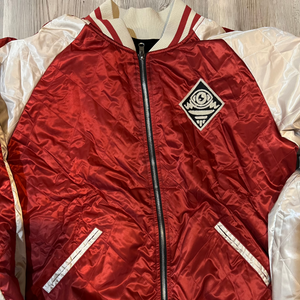 Close-up of chenille “Mindzai” lettering and embroidered skulls on Femme Fatale Jacket.