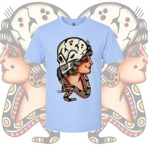 Light blue t-shirt with a graphic design of a stylized face on a patterned background