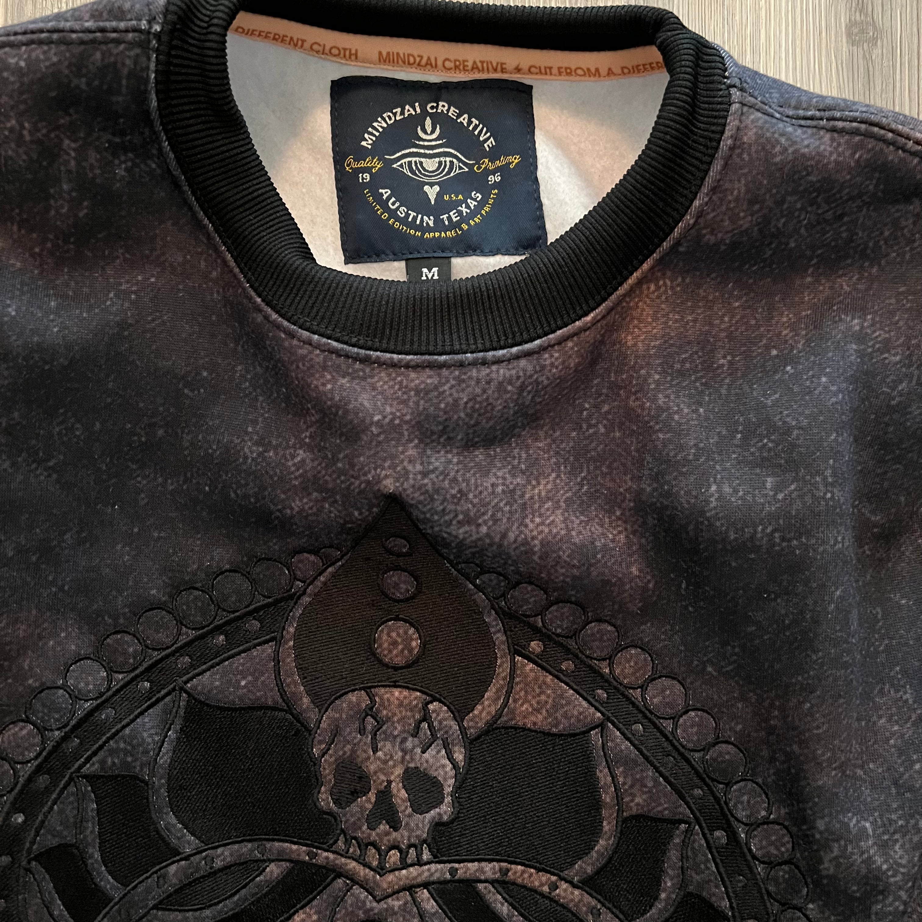 Flat-lay of the Kali Sweatshirt showing full artwork and fabric layout.