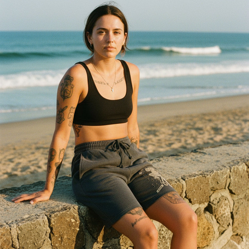 Woman sitting on a stone wall by the ocean
