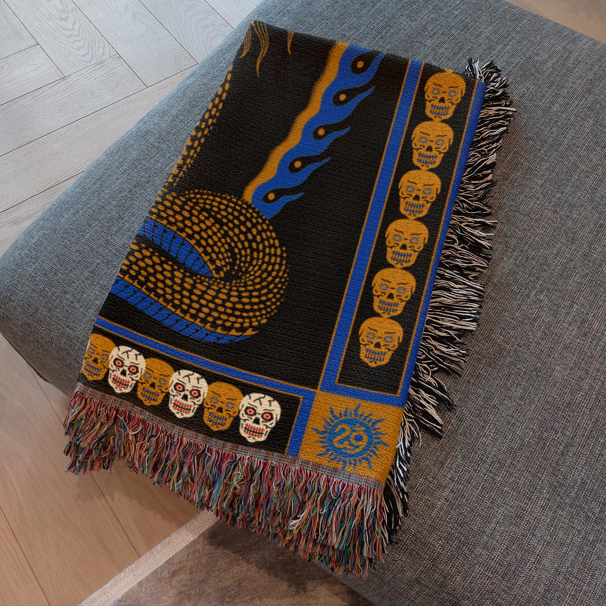 Snake Charmer Blanket draped over couch as wall art and décor piece.